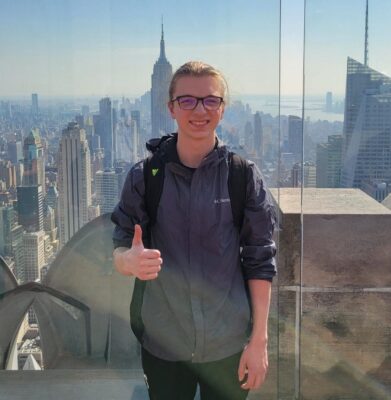 Kyler Misenheimer in New York City with the Empire State Building behind him